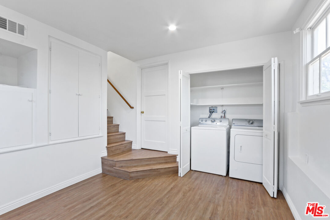 3851 Olympiad Drive View Park, CA 90043 - Photo 32 of 35 a view of walk in closet with wooden floor and staircase