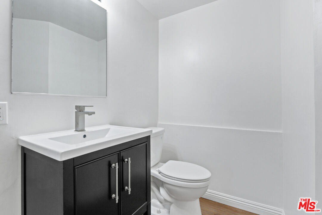 3851 Olympiad Drive View Park, CA 90043 - Photo 33 of 35 a bathroom with a sink vanity and a toilet