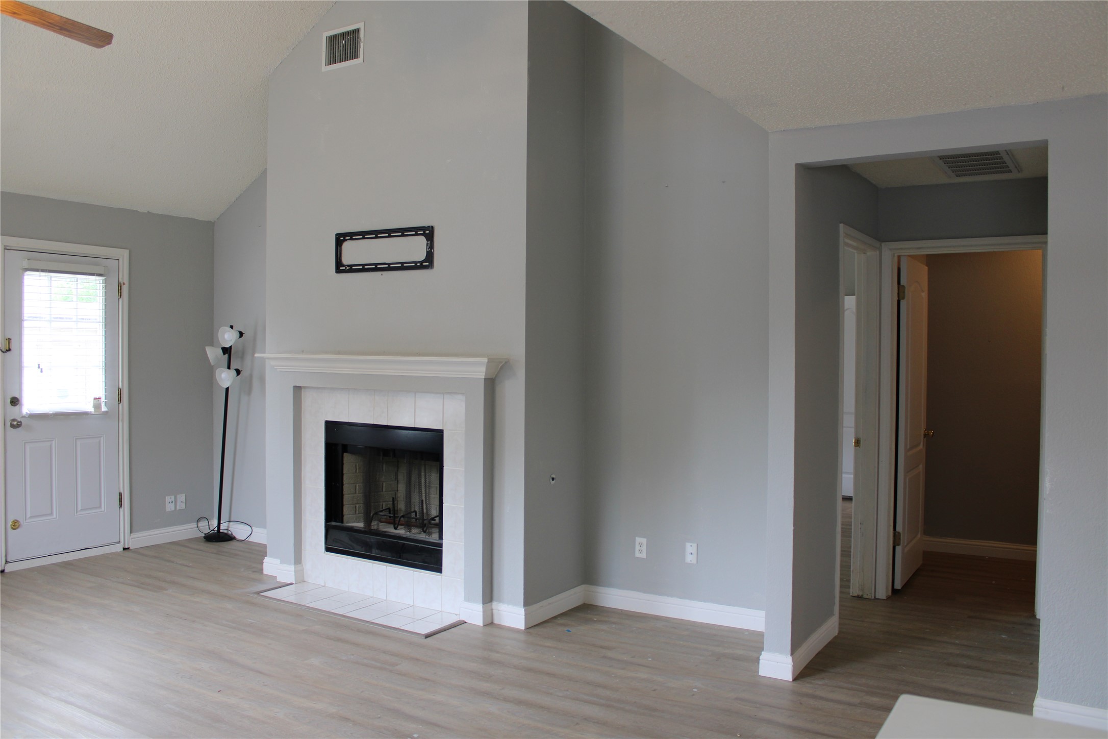 16205 Glorious Lane Pflugerville, TX 78660 - Photo 10 of 30 a view of a livingroom with a fireplace wooden floor and staircase