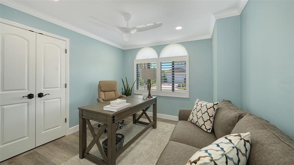 595 Bowsprit Lane Longboat Key, FL 34228 - Photo 11 of 31 a living room with furniture and a window