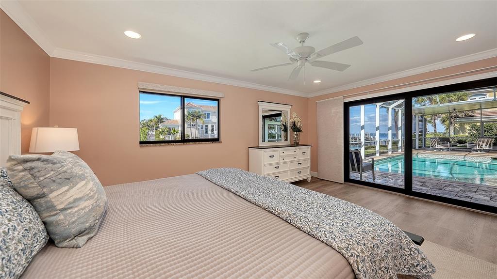 595 Bowsprit Lane Longboat Key, FL 34228 - Photo 12 of 31 a bedroom with a large bed and a large window