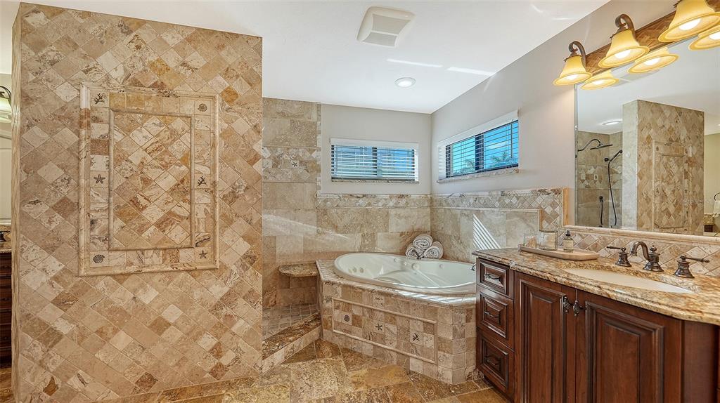 595 Bowsprit Lane Longboat Key, FL 34228 - Photo 14 of 31 a bathroom with a granite countertop sink a toilet and a shower
