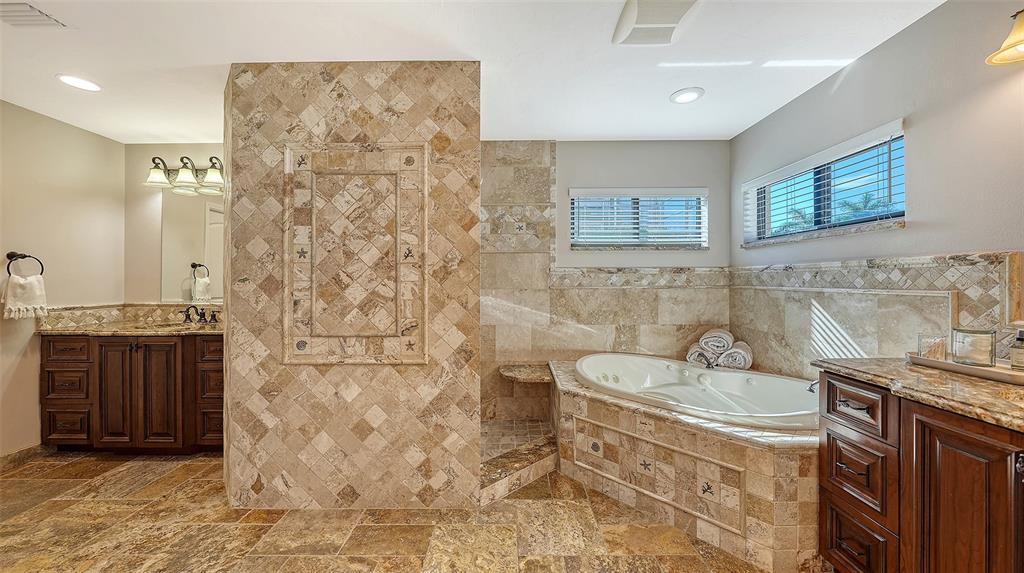 595 Bowsprit Lane Longboat Key, FL 34228 - Photo 15 of 31 a bathroom with a sink and a mirror