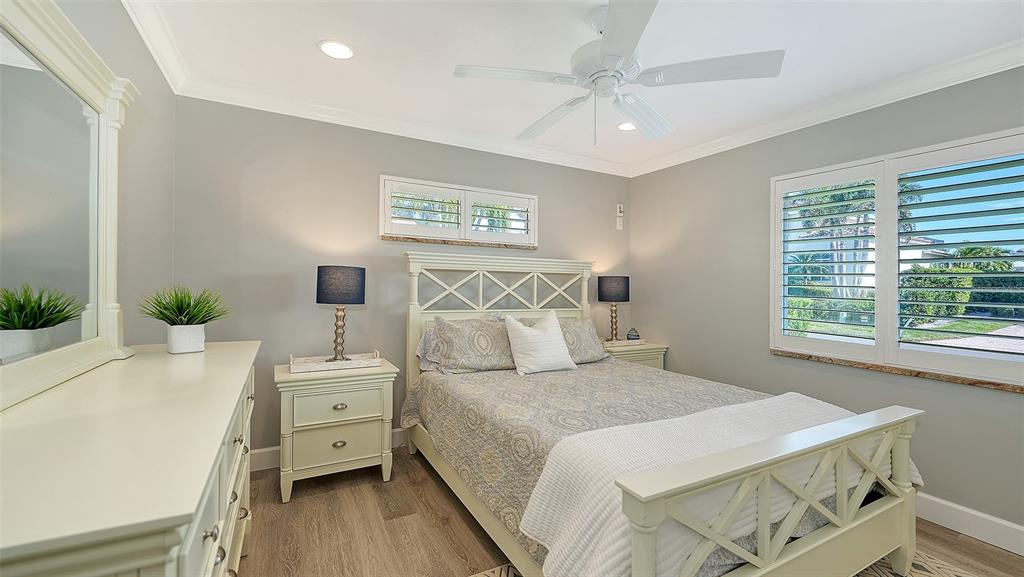595 Bowsprit Lane Longboat Key, FL 34228 - Photo 16 of 31 a bedroom with a bed and a table