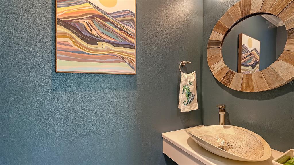 595 Bowsprit Lane Longboat Key, FL 34228 - Photo 19 of 31 a bathroom with a sink and a mirror