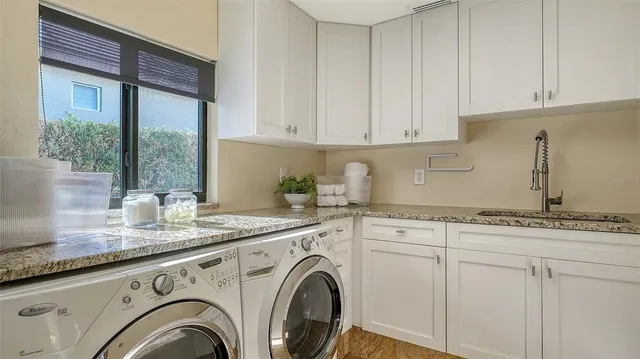 a view of kitchen with granite countertop cabinets