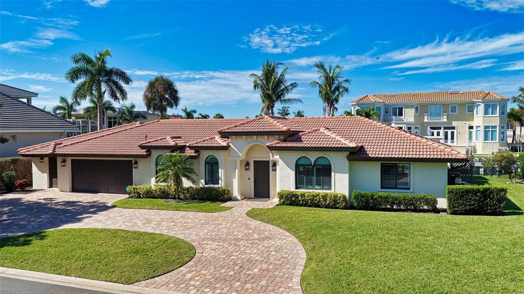 595 Bowsprit Lane Longboat Key, FL 34228 - Photo 2 of 31 a front view of a house with a garden