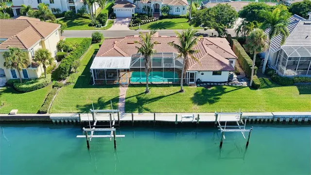 an aerial view of a house with a garden and lake view
