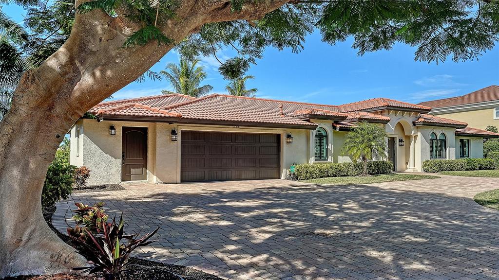595 Bowsprit Lane Longboat Key, FL 34228 - Photo 29 of 31 a front view of a house with a garden