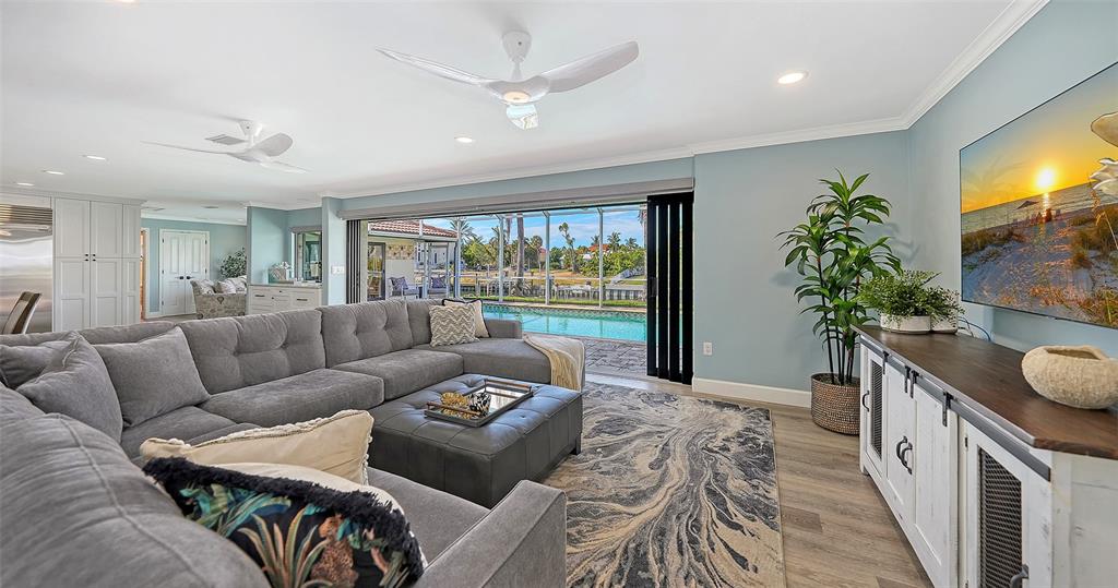 595 Bowsprit Lane Longboat Key, FL 34228 - Photo 3 of 31 a living room with furniture and a flat screen tv