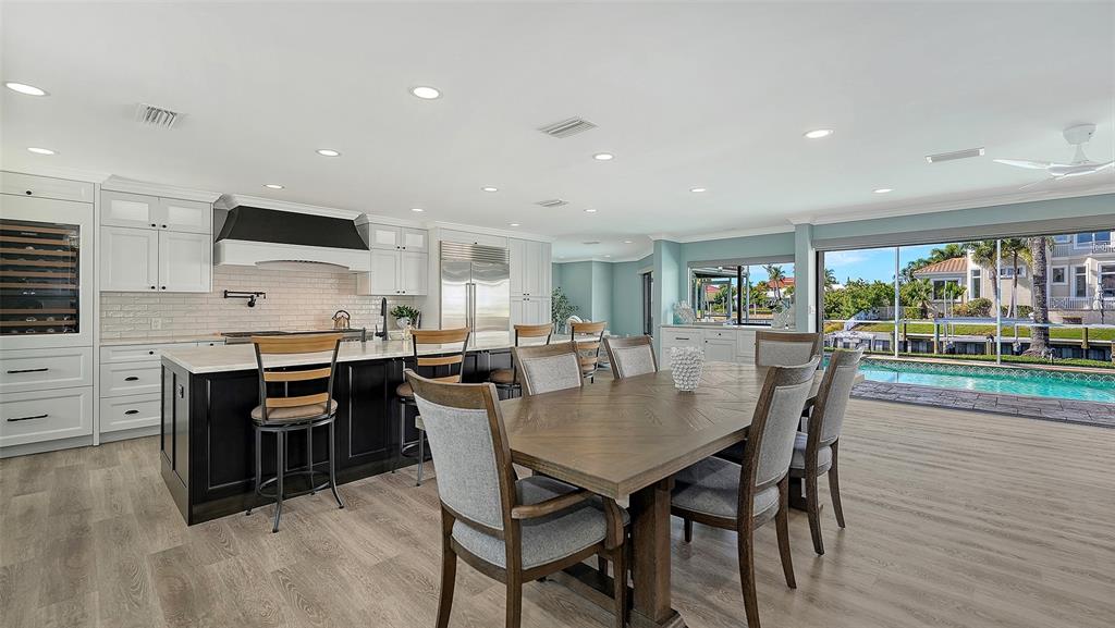 595 Bowsprit Lane Longboat Key, FL 34228 - Photo 5 of 31 a view of a dining room with furniture and wooden floor
