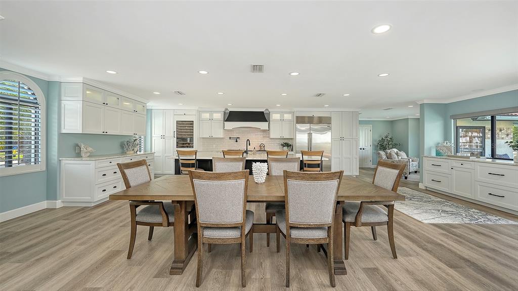 595 Bowsprit Lane Longboat Key, FL 34228 - Photo 7 of 31 a view of a dining room with furniture and wooden floor