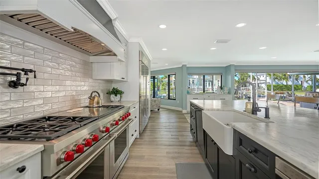 a kitchen with stove and wooden floor
