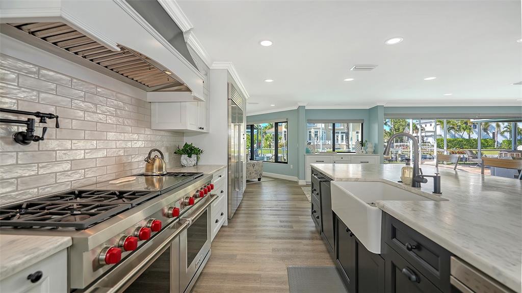 595 Bowsprit Lane Longboat Key, FL 34228 - Photo 8 of 31 a kitchen with stove and wooden floor