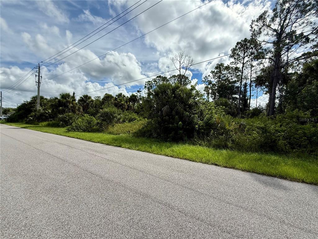 Oceanside St Port North Port, FL 34286 - Photo 9 of 11 a view of a street with a yard and large trees