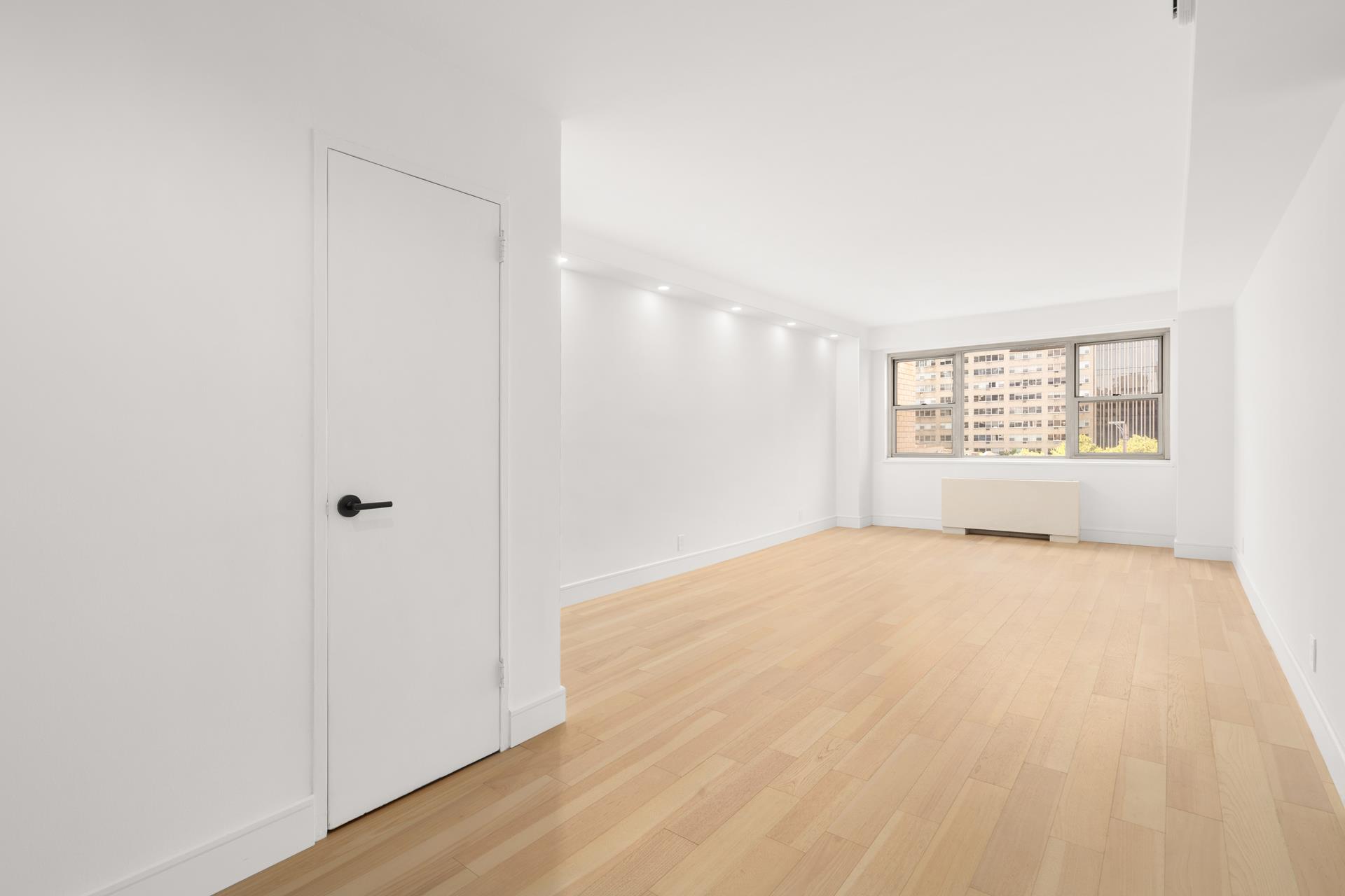 321 East 48th Street, Unit 11H Manhattan, NY 10017 - Photo 3 of 8 a view of an empty room with a window