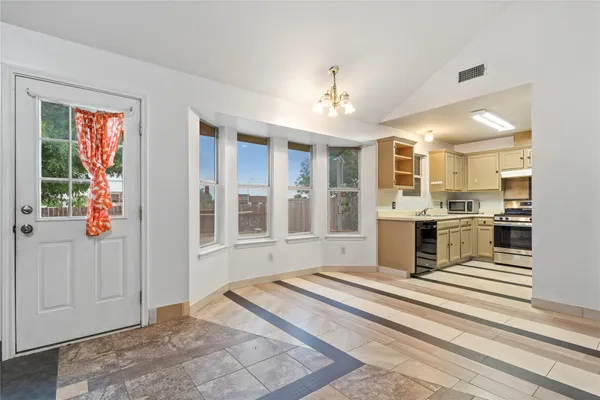 a spacious bedroom with a large bed and a window