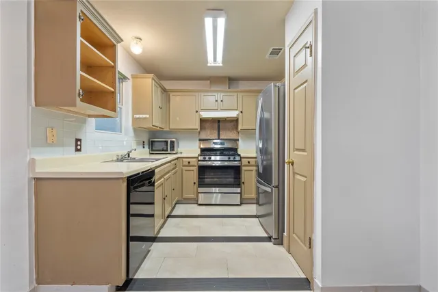 a kitchen with a refrigerator and a sink