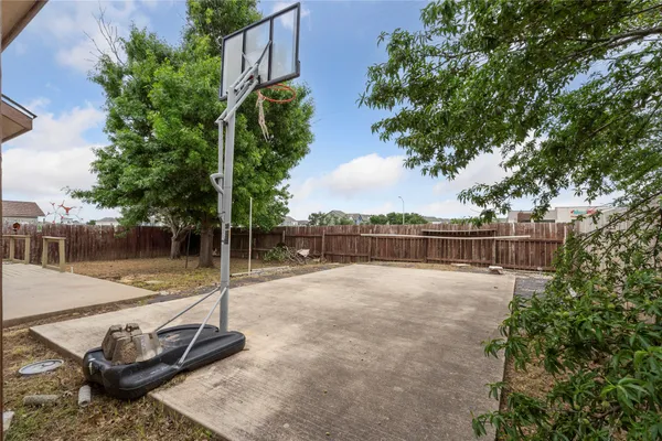a backyard of a house with wooden floor and fence