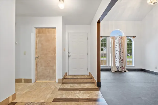 a view of an entryway with wooden floor and a window