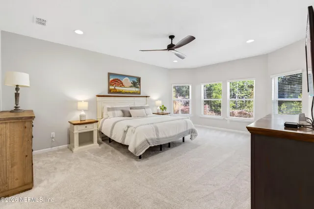 a bedroom with a large bed and a desk