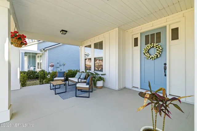 a view of a patio with table and chairs and potted plants