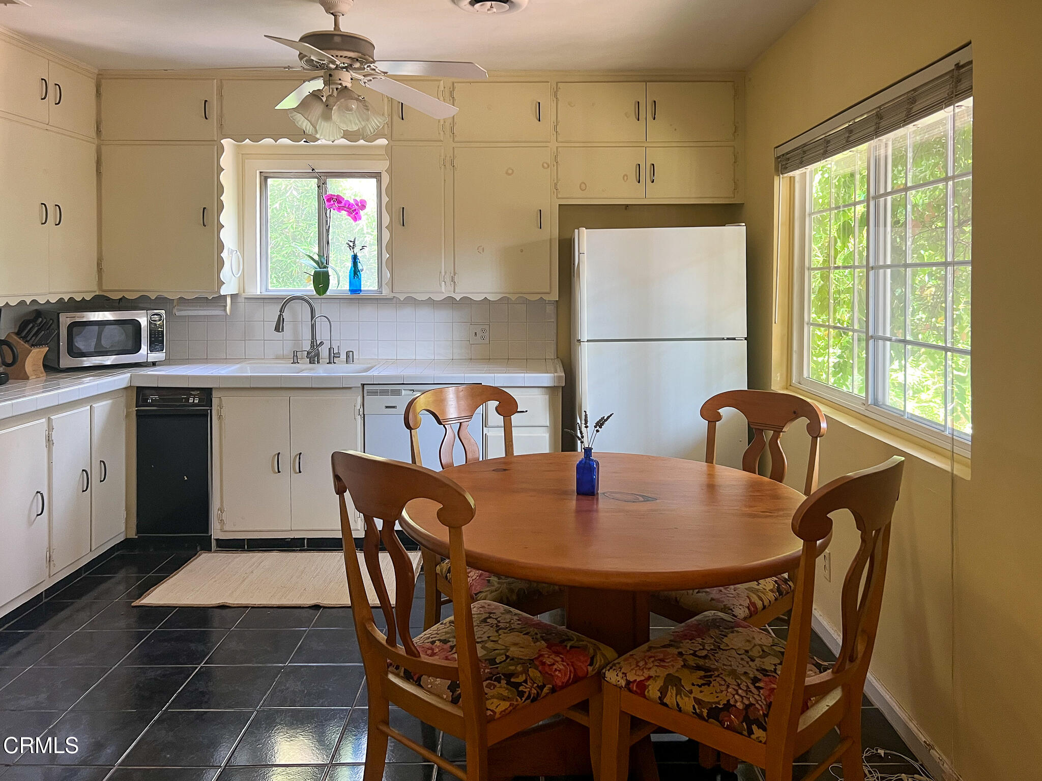 14135 Hatteras Street Sherman Oaks, CA 91401 - Photo 15 of 39 a view of a dining room and kitchen with a table chairs a workspace and a window