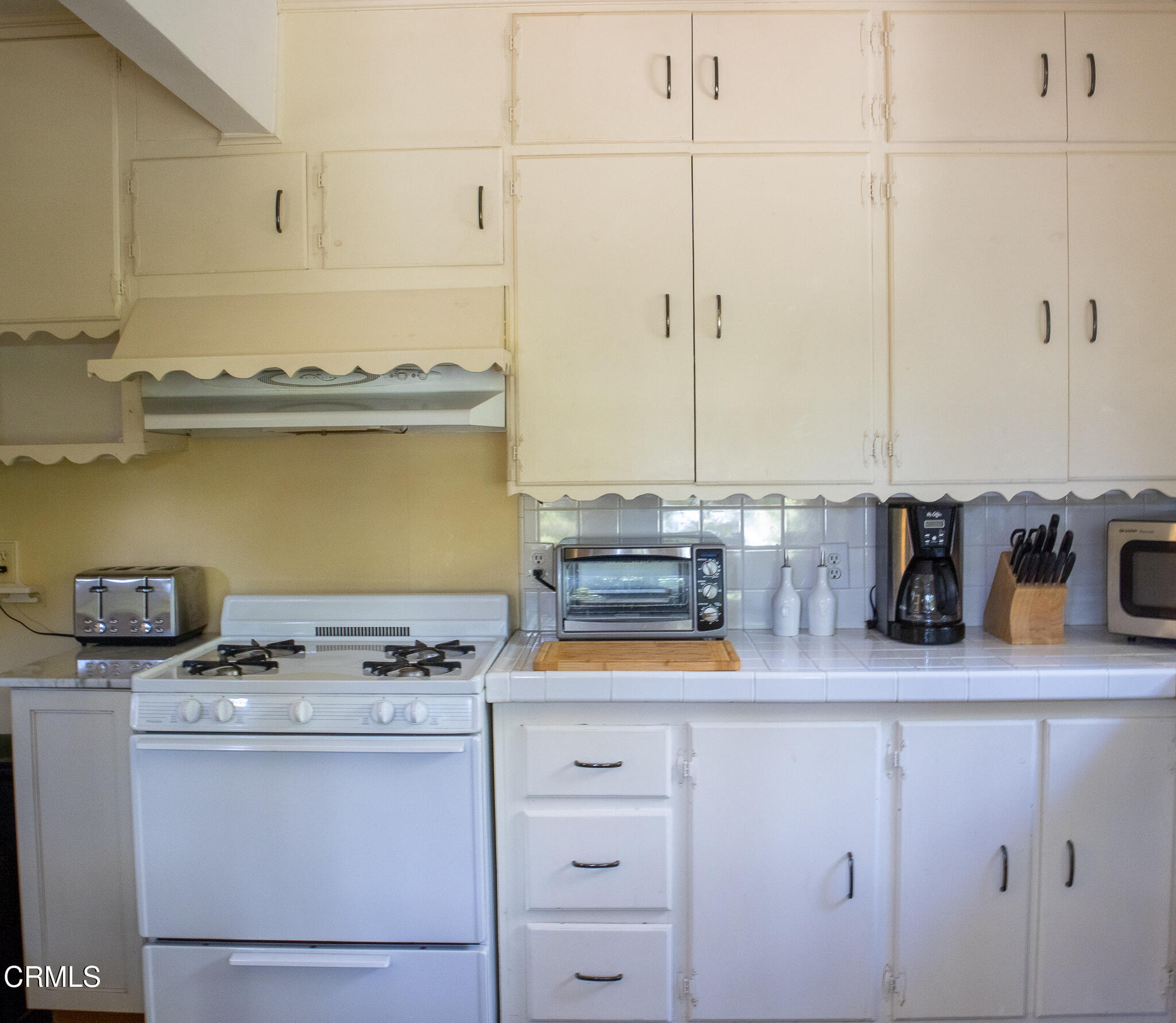 14135 Hatteras Street Sherman Oaks, CA 91401 - Photo 16 of 39 a kitchen with stainless steel appliances granite countertop a sink stove and cabinets