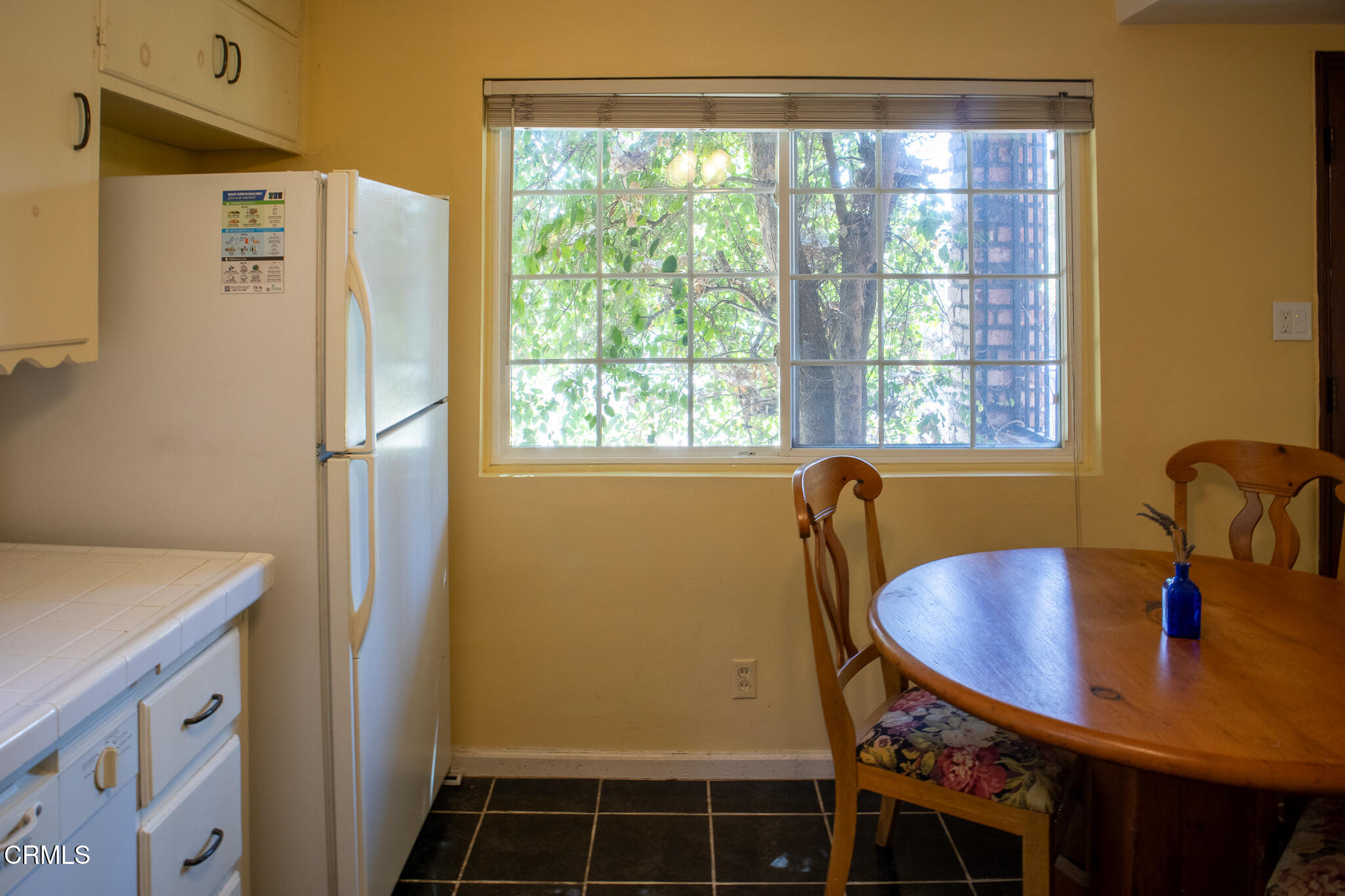14135 Hatteras Street Sherman Oaks, CA 91401 - Photo 18 of 39 a bathroom with a sink a window and a refrigerator