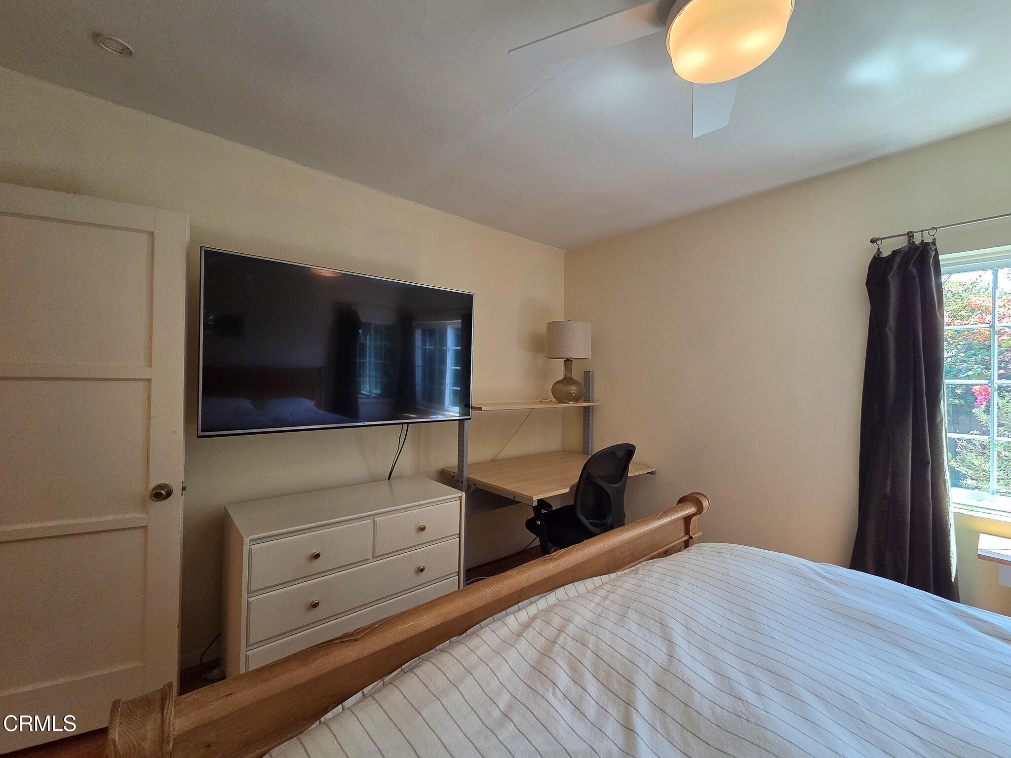 14135 Hatteras Street Sherman Oaks, CA 91401 - Photo 23 of 39 a bedroom with a bed and a flat tv screen on the dresser