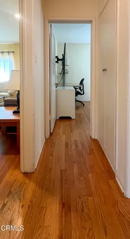 a view of a room with wooden floor