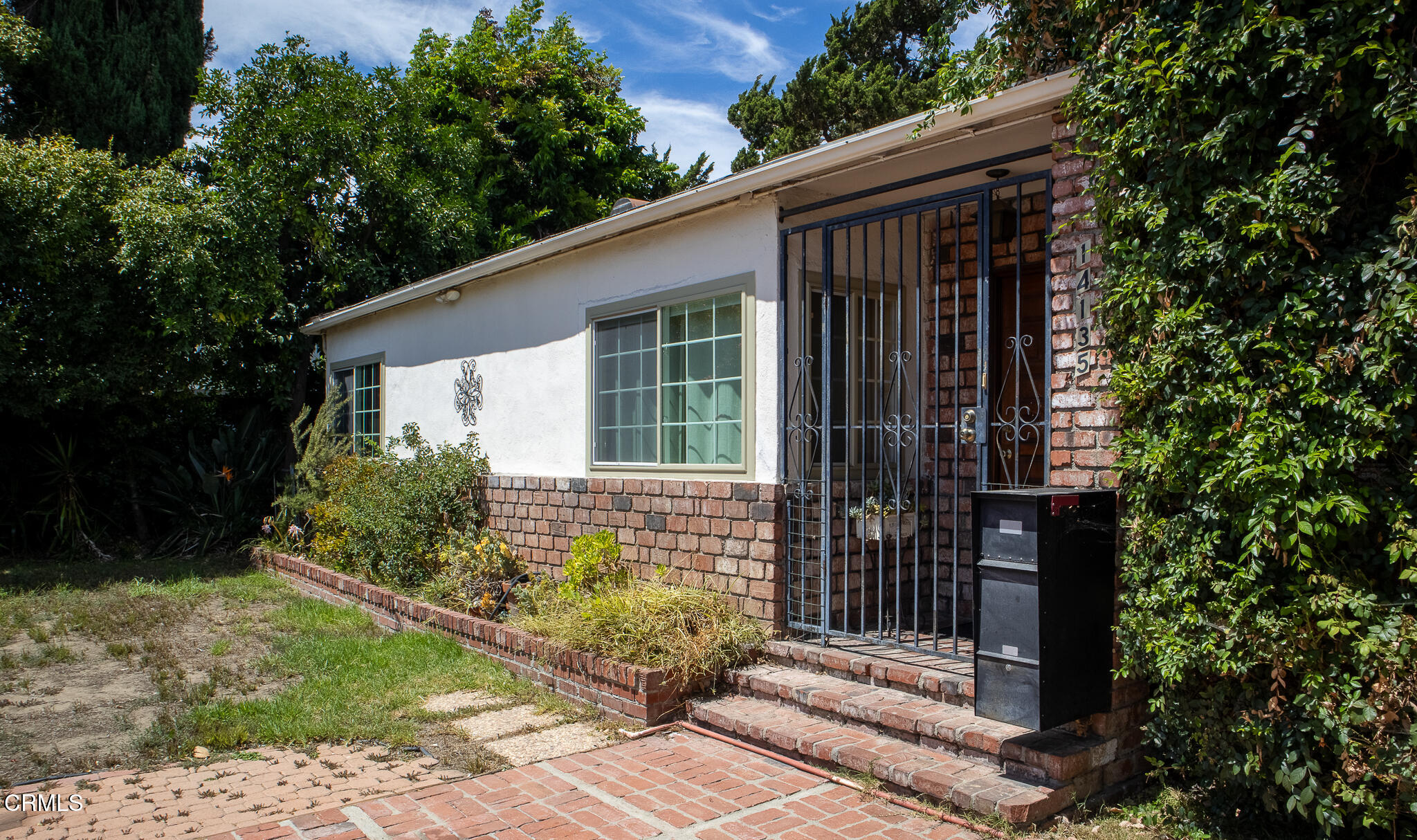 14135 Hatteras Street Sherman Oaks, CA 91401 - Photo 3 of 39 a front view of a house with garden