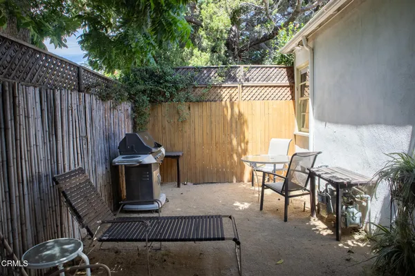 a view of backyard with outdoor seating and trees