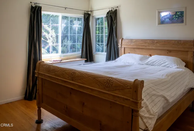 a view of a bedroom with a balcony and a tub