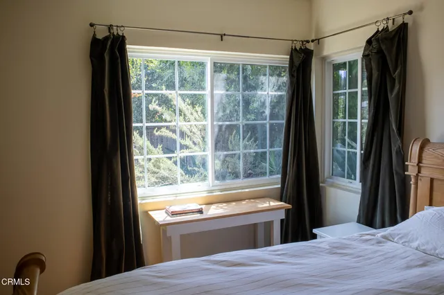 a bed room with a bed and a window