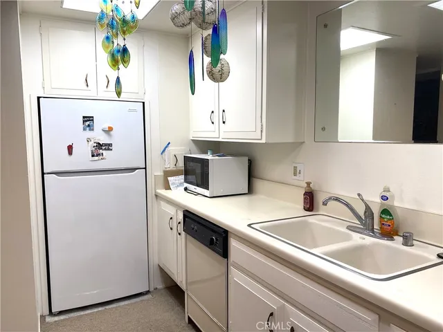 a kitchen with appliances a sink and a window