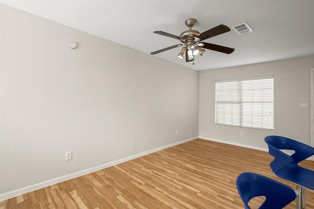 1013 West 23rd Street, Unit 104 Austin, TX 78705 - Photo 7 of 11 Sitting room featuring light wood-style floors and a ceiling fan