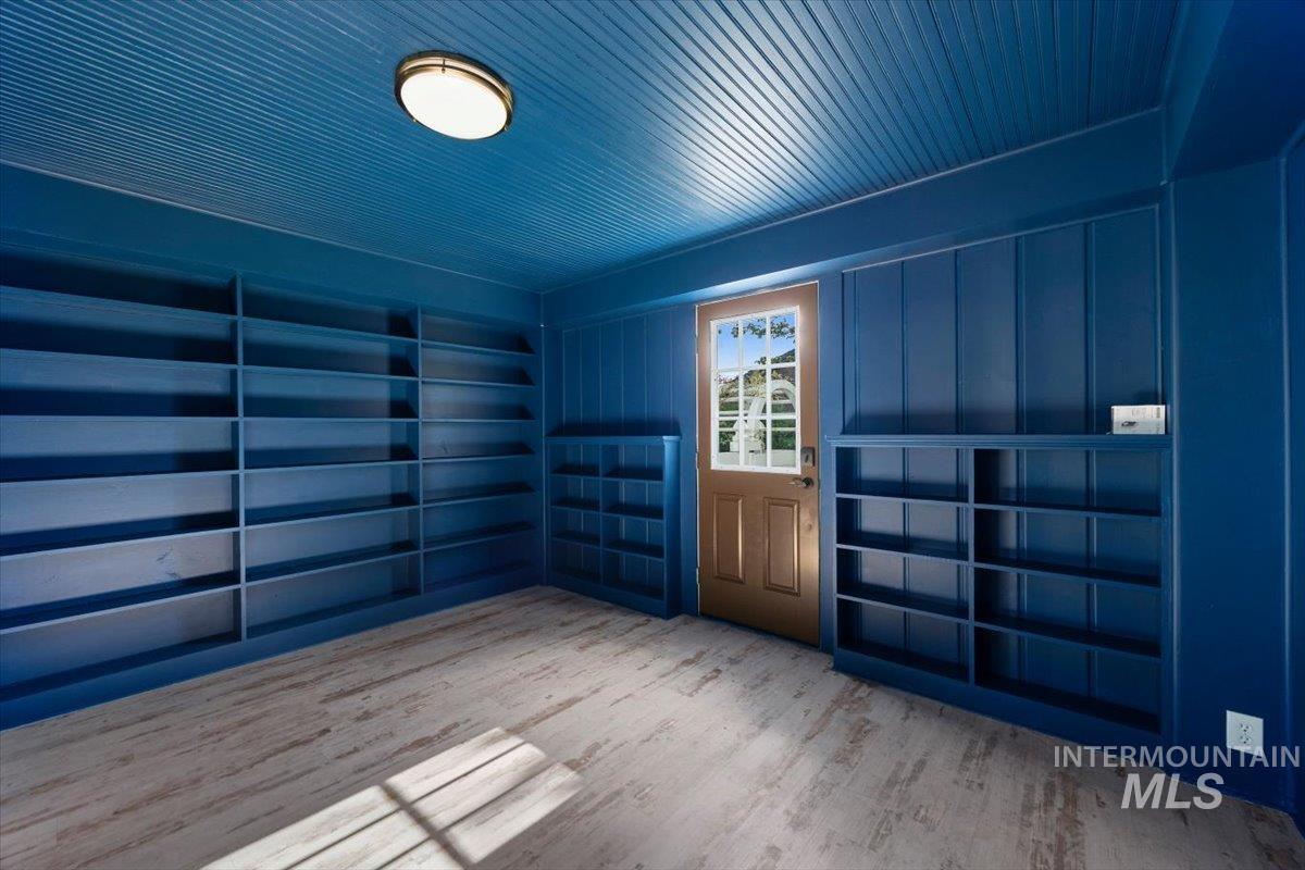 813 7th Street Rupert, ID 83350 - Photo 13 of 48 Room with extensive built-in shelving, wood-finish flooring, and a beadboard ceiling
