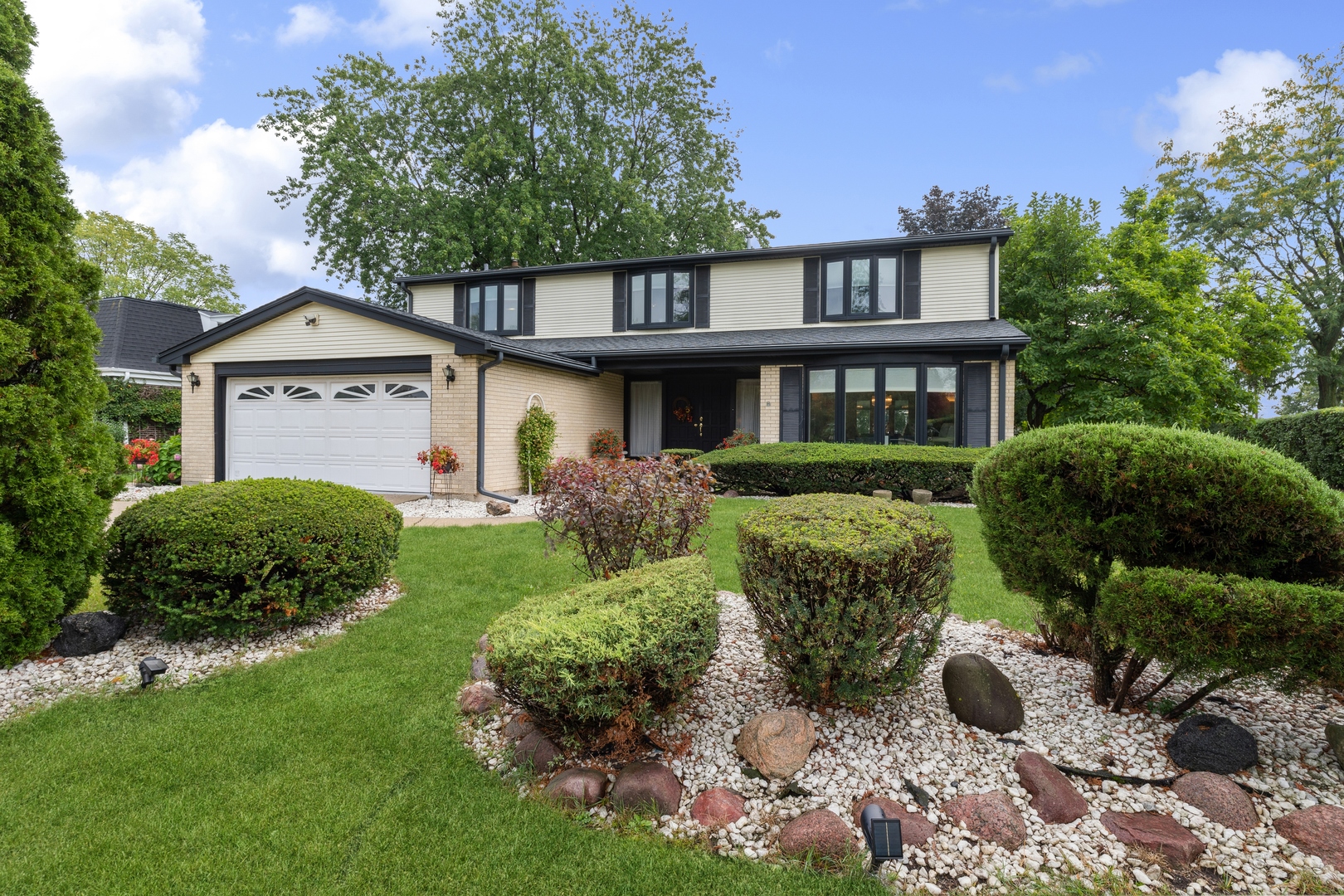a front view of a house with garden