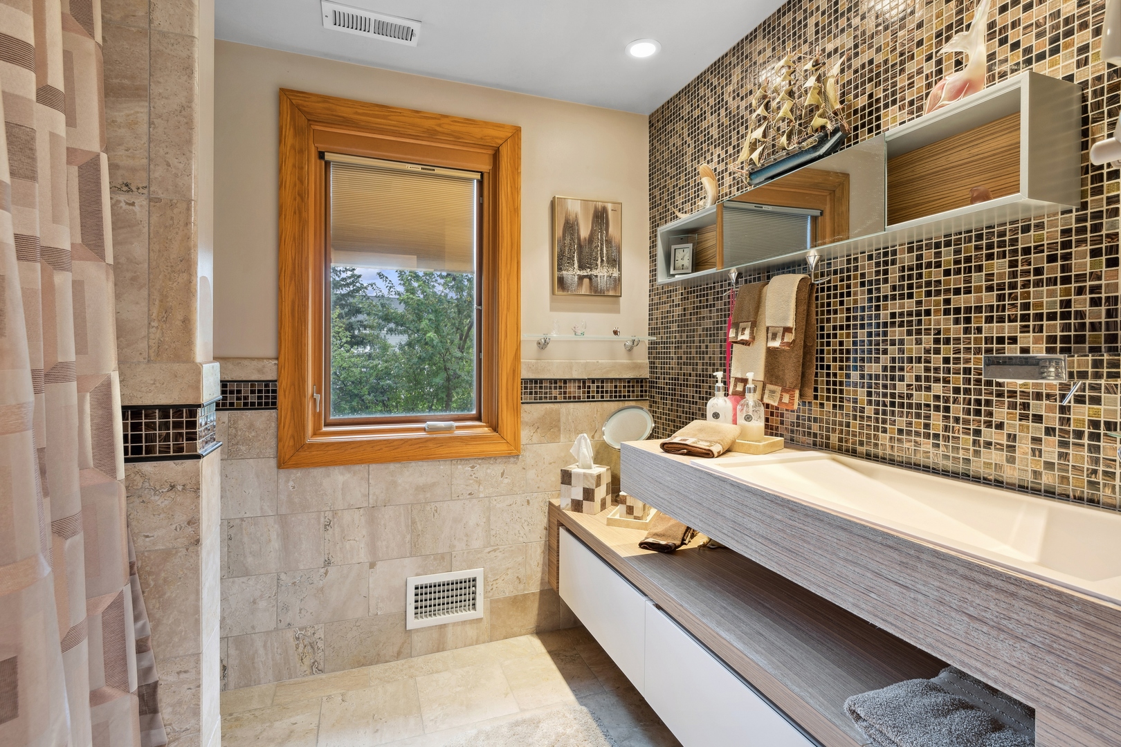 3731 Winnetka Road Glenview, IL 60026 - Photo 16 of 26 a bathroom with a granite countertop bathtub a sink and a window