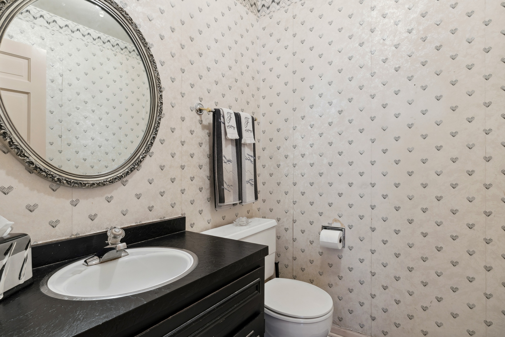 3731 Winnetka Road Glenview, IL 60026 - Photo 21 of 26 a bathroom with a sink a toilet and a mirror