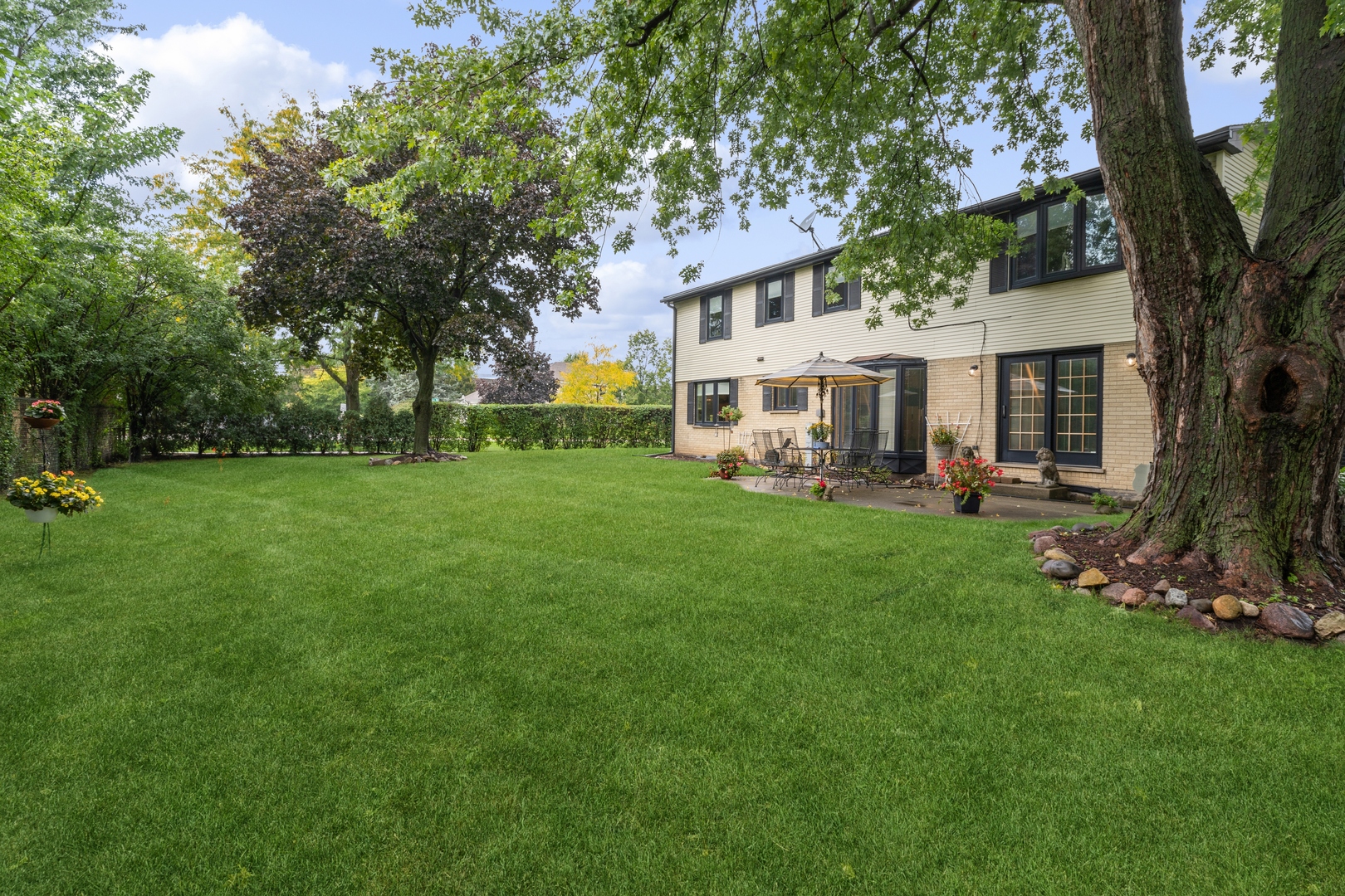 3731 Winnetka Road Glenview, IL 60026 - Photo 23 of 26 a view of a white house in front of a big yard with large trees