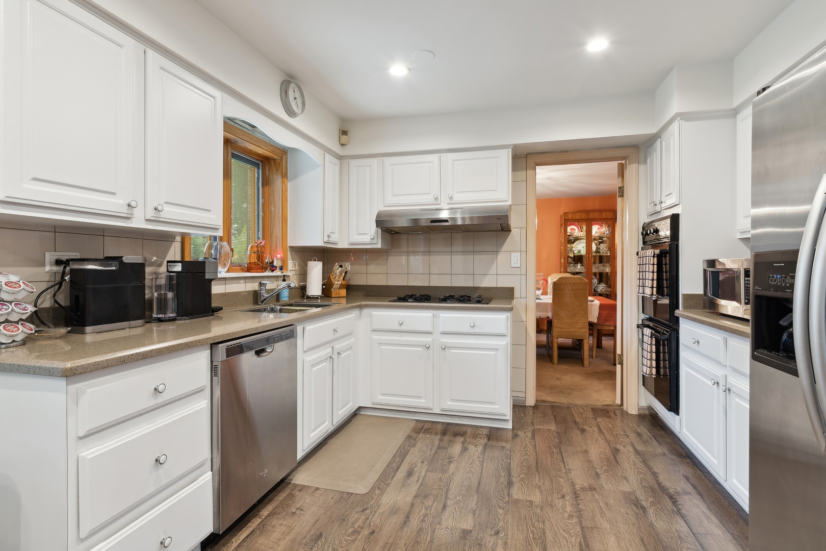3731 Winnetka Road Glenview, IL 60026 - Photo 4 of 26 a kitchen with white cabinets and stainless steel appliances