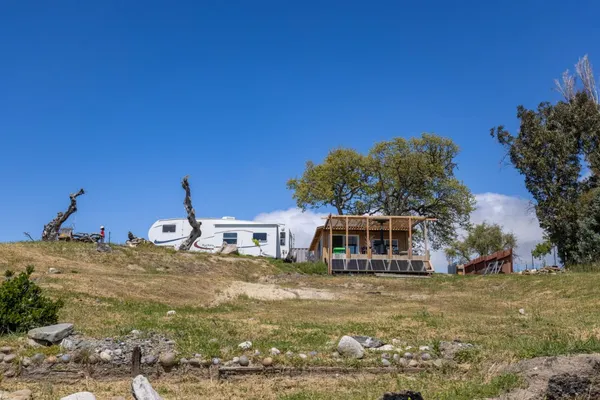 a view of a house with swimming pool and sitting area