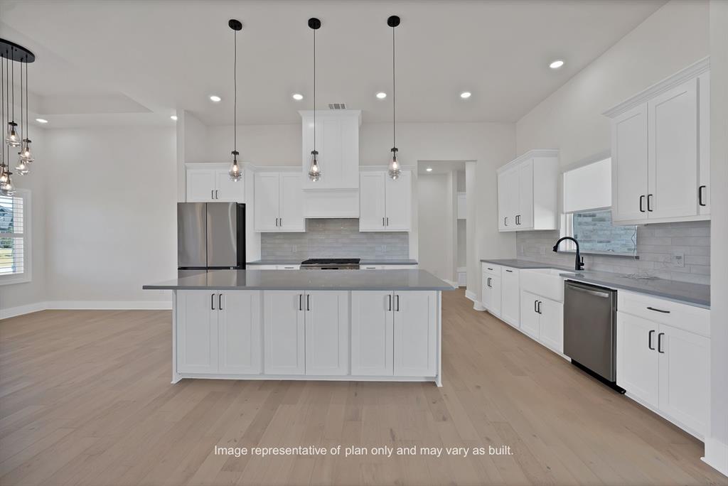 10641 Rye Bread Lane Venus, TX 76084 - Photo 5 of 13 a large white kitchen with stainless steel appliances granite countertop a stove a sink a refrigerator and white cabinets