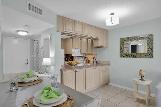 a kitchen with stainless steel appliances kitchen island granite countertop a sink and cabinets