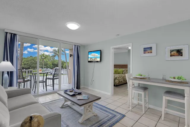 a living room with furniture and a floor to ceiling window