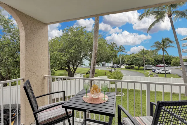 a view of a chair and tables in the balcony