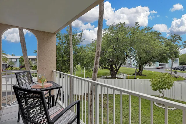 a view of a balcony with two chairs and a table