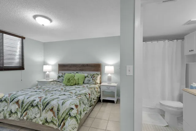 a bedroom with a bed and a lamp